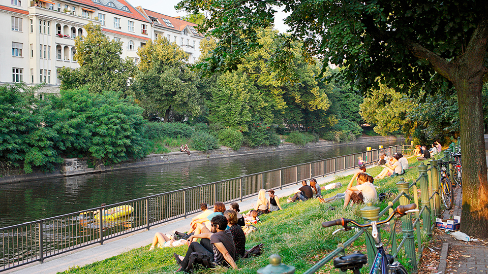 people enjoying time at a riverbank in Berlin in summer